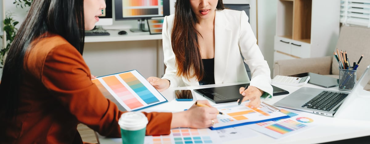 Designers reviewing a color palette for a hospital website concept.